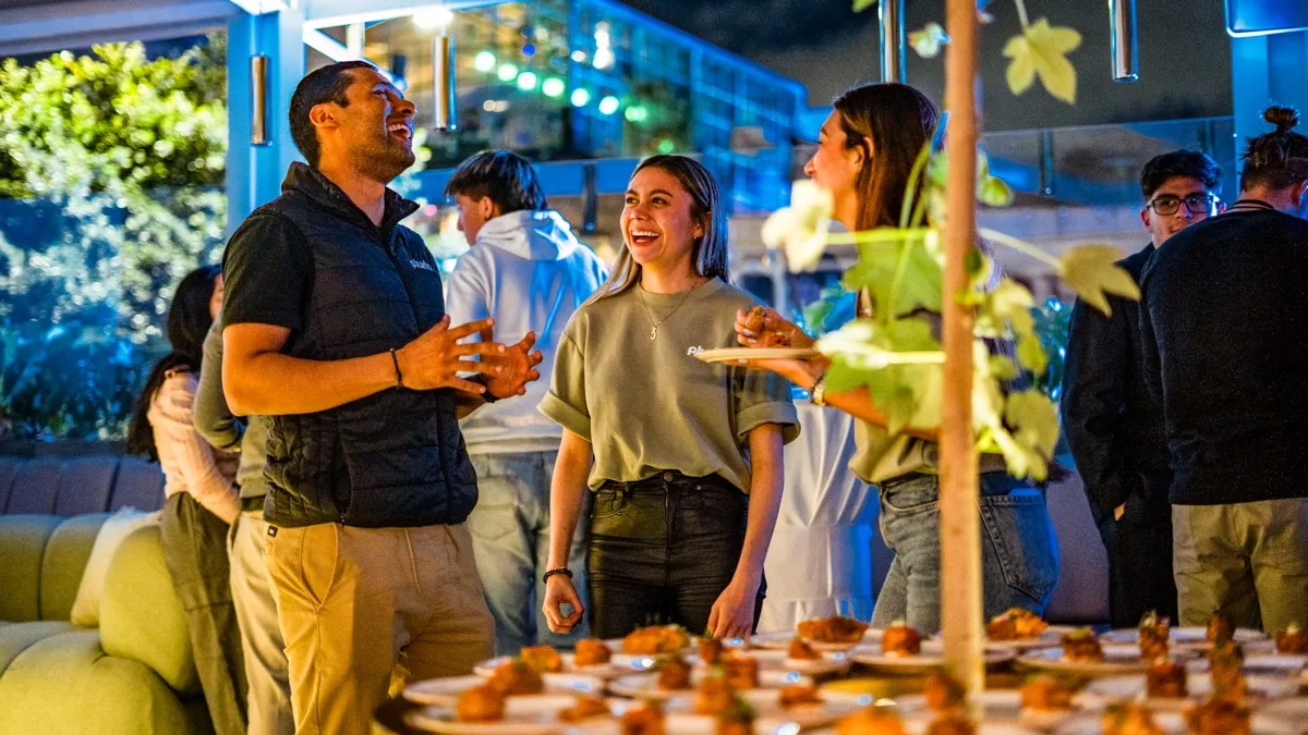 Guests talking over canapés at an evening reception