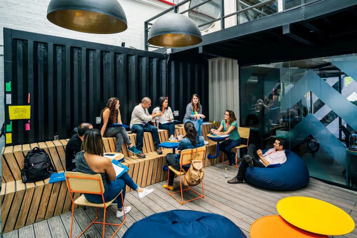 A workshop in progress on tiered seating in a coworking space